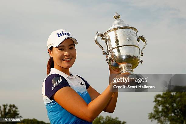 In Gee Chun of South Korea poses with the trophy after winning the U.S. Women's Open at Lancaster Country Club on July 12, 2015 in Lancaster,...