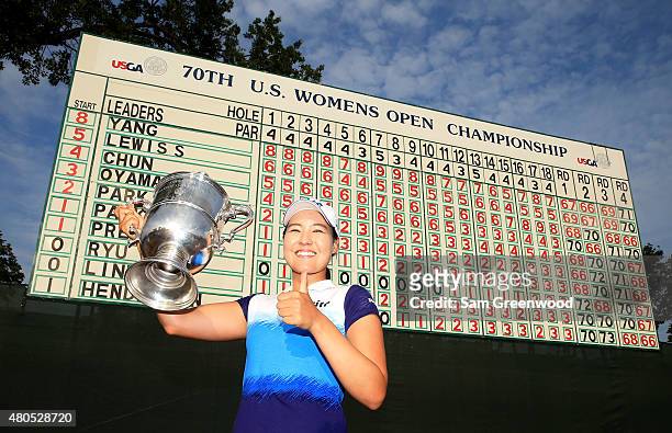 In Gee Chun of South Korea poses with the trophy after winning the U.S. Women's Open at Lancaster Country Club on July 12, 2015 in Lancaster,...