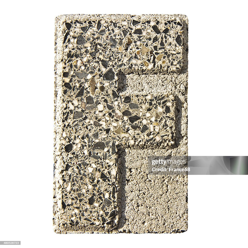 Letter F carved in a concrete block