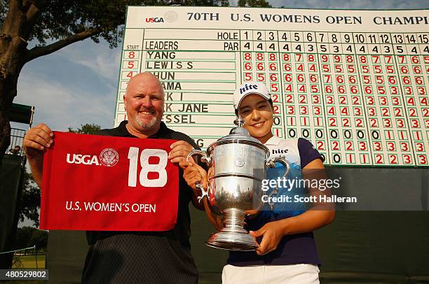 In Gee Chun of South Korea poses with the trophy and her caddie Dean Herden after winning the U.S. Women's Open at Lancaster Country Club on July 12,...