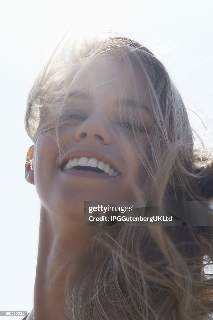 Closeup Of Cheerful Woman With Windy Hair