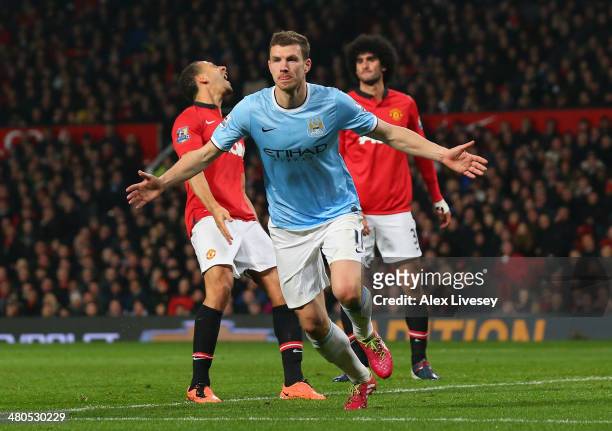Edin Dzeko of Manchester City celebrates scoring the second goal during the Barclays Premier League match between Manchester United and Manchester...