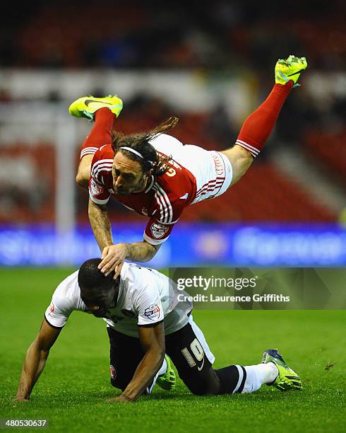 Jonathan Greening of Nottingham Forest battles with Marvin Sordell of Charlton Athletic during the Sky bet Championship match between Nottingham...