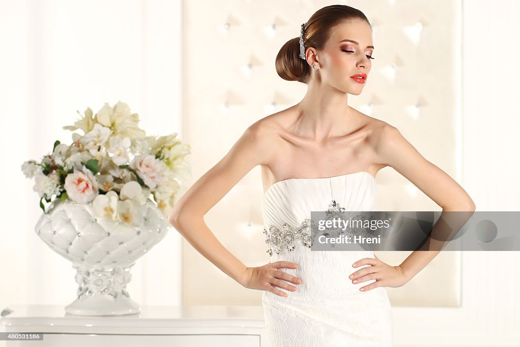 Gorgeous bride in a white room, posing