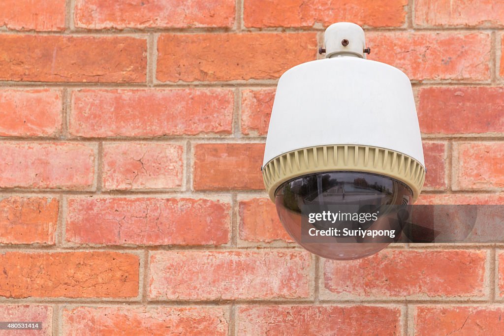 Security Camera CCTV On The Brick Wall.