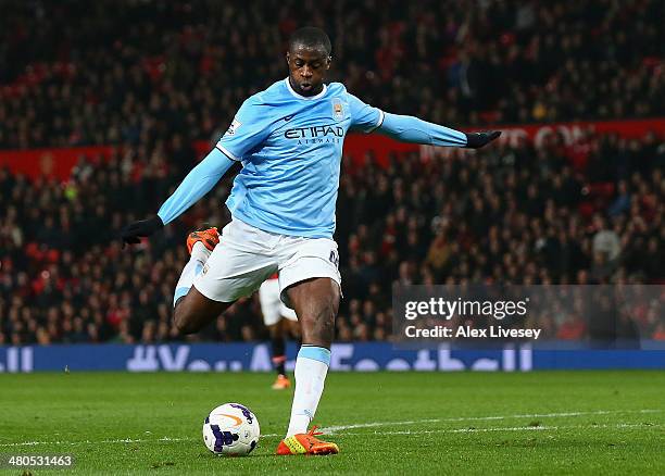 Yaya Toure of Manchester City scores the third goal during the Barclays Premier League match between Manchester United and Manchester City at Old...