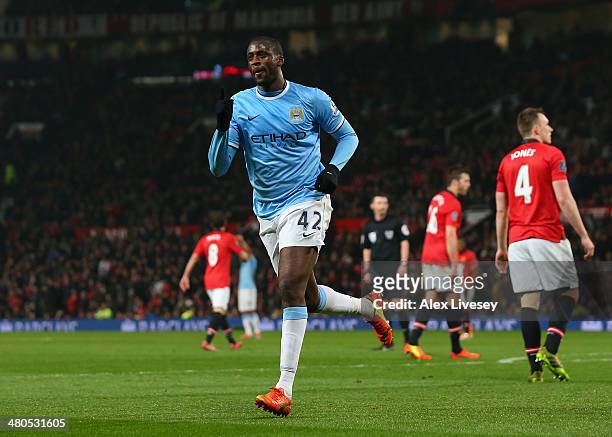 Yaya Toure of Manchester City celebrates scoring the third goal during the Barclays Premier League match between Manchester United and Manchester...
