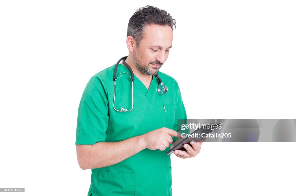 Modern doctor browsing internet with wireless tablet