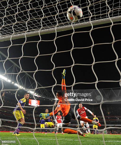 Lukas Podolski scores Arsenal's 1st goal past Michel Vorm of Swansea during the match between Arsenal and Swansea City in the Barclays Premier League...