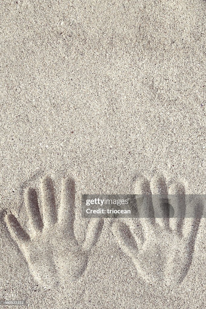 Hand prints on the sand