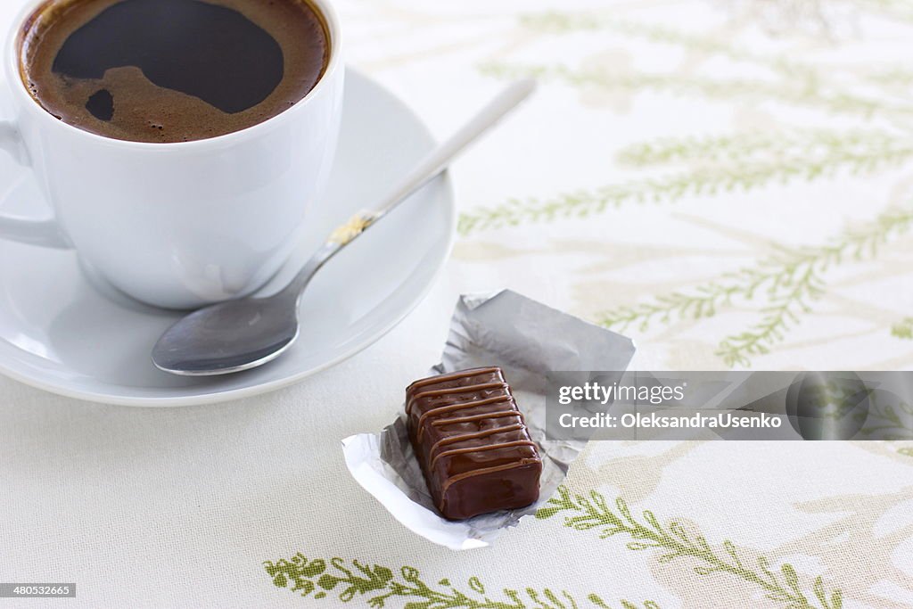 Cup of coffee and chocolate candy