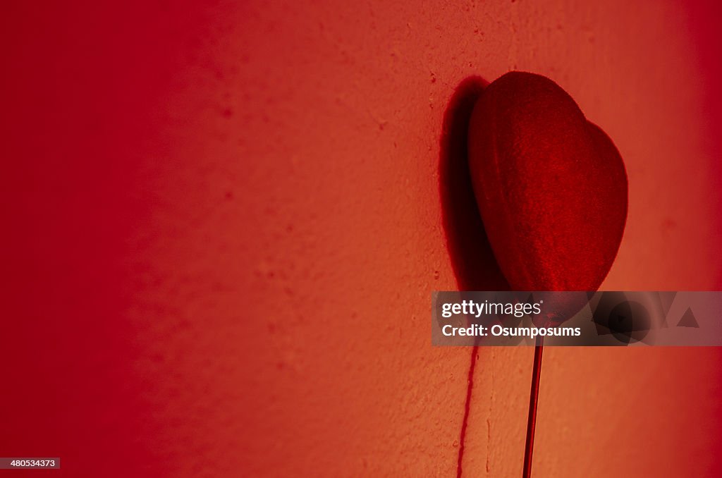 Beautiful red heart play game with a shadow on wall