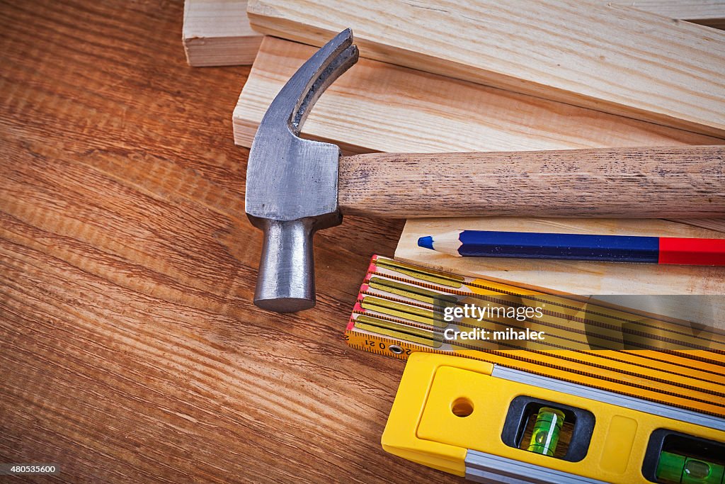 Pencil wooden meter and bricks construction level claw hammer on