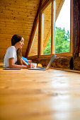 Woman relaxing in wooden house