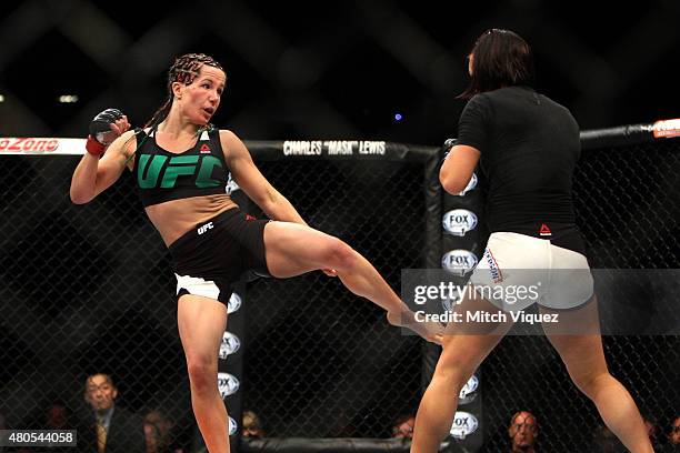 Angela Magana kicks Michelle Waterson in their women's strawweight bout during the Ultimate Fighter Finale inside MGM Grand Garden Arena on July 12,...