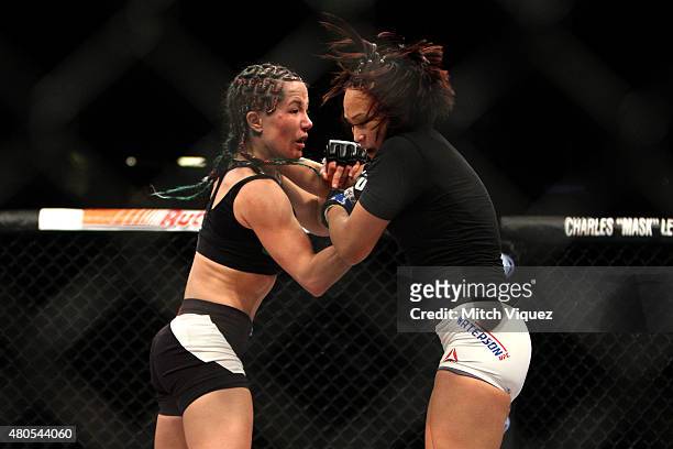 Angela Magana punches Michelle Waterson in their women's strawweight bout during the Ultimate Fighter Finale inside MGM Grand Garden Arena on July...