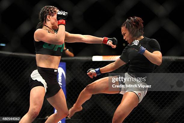 Angela Magana punches Michelle Waterson in their women's strawweight bout during the Ultimate Fighter Finale inside MGM Grand Garden Arena on July...