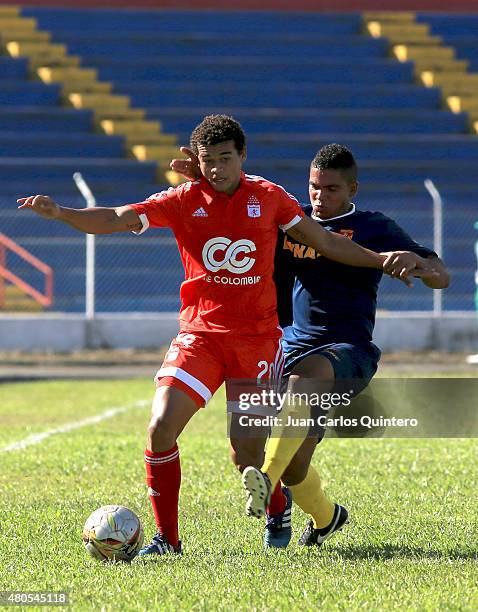 Cristian Subero of America de Cali battles for the ball with Daniel Restrepo of Bogota FC during a match between America de Cali and Bogota FC as...