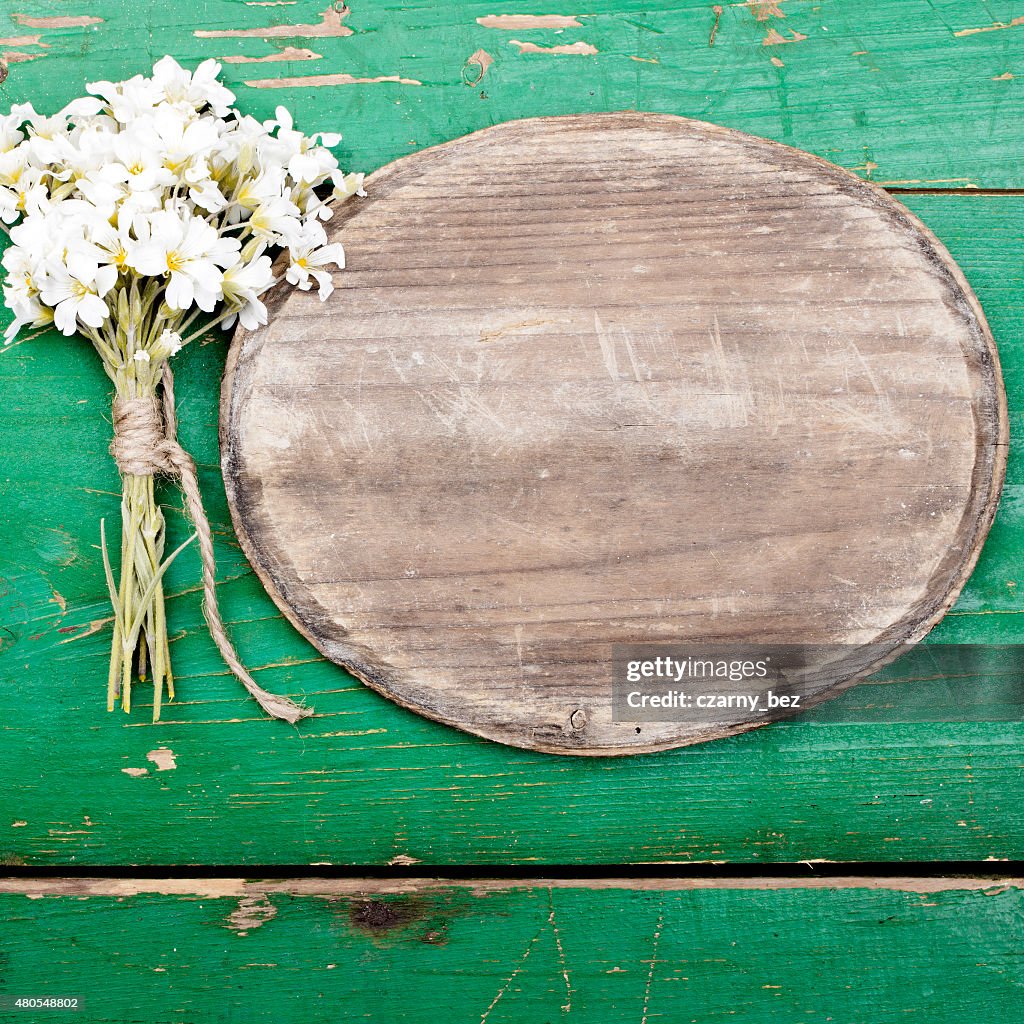 Oval plaque and a bouquet of flowers