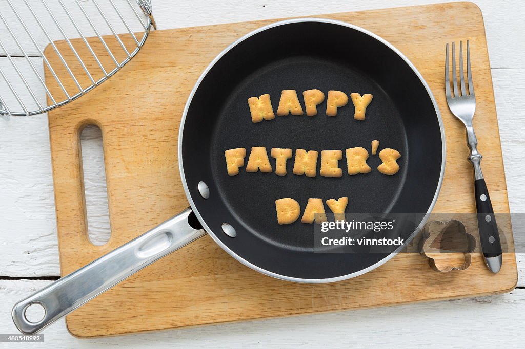 Cookie biscuits word HAPPY FATHER'S DAY in frying pan