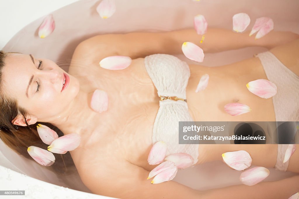 Woman resting in spa bathtub
