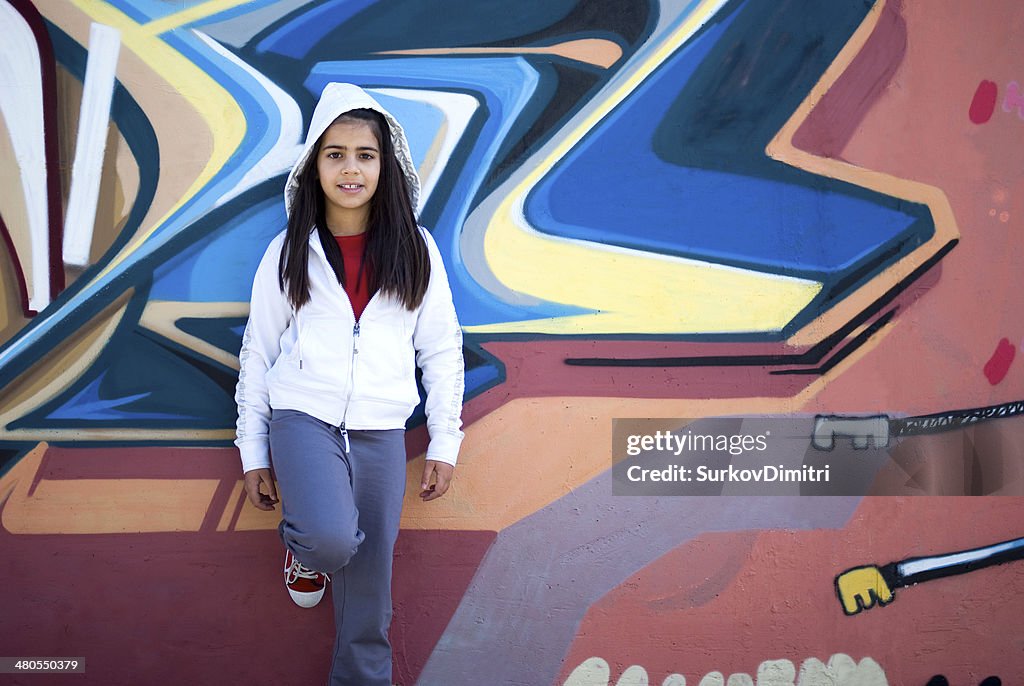 Girl against graffiti wall
