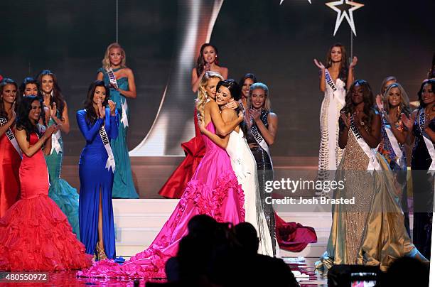 Miss USA Olivia Jordan of Oklahoma and Miss Texas Ylianna Guerra hug onstage at the 2015 Miss USA Pageant Only On ReelzChannel at The Baton Rouge...