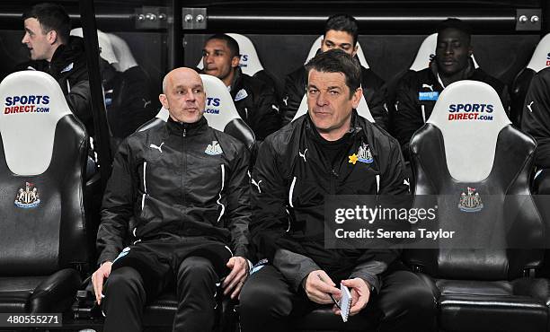 Newcastle Assistant Manager John Carver sits in the dugout with First Team Coach Steve Stone during the Barclays Premier League match between...