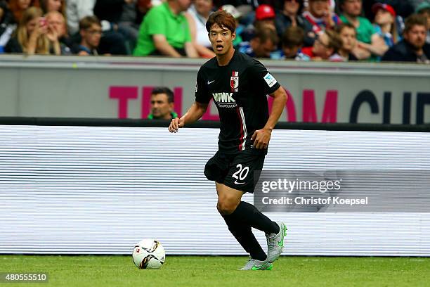Jeong-Ho Hong of Augsburg runs with the ball during the Telekom Cup 2015 Semi Final match between Borussia Moenchegladbach and Hamburger SV at...