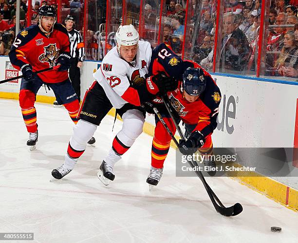 Chris Neil of the Ottawa Senators shoves Krys Barch of the Florida Panthers at the BB&T Center on March 25, 2014 in Sunrise, Florida.