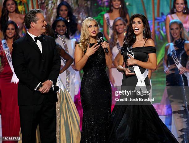 Hosts Todd Newton and Former Miss Wisconsin Alex Wehrley speak with Most Photogenic winner Miss Montana Tahnee Peppenger on stage at the 2015 Miss...