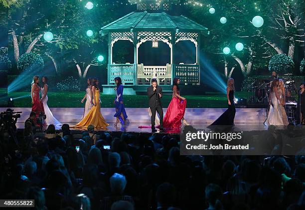 Travis Garland performs onstage with Miss USA contestants at 2015 Miss USA Pageant Only On ReelzChannel at The Baton Rouge River Center on July 12,...