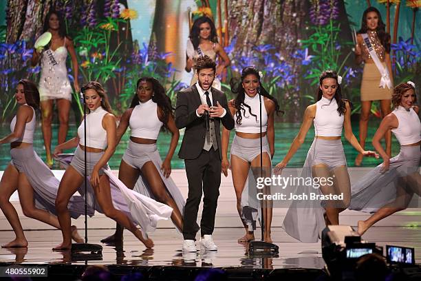 Travis Garland performs onstage with Miss USA contestants at 2015 Miss USA Pageant Only On ReelzChannel at The Baton Rouge River Center on July 12,...