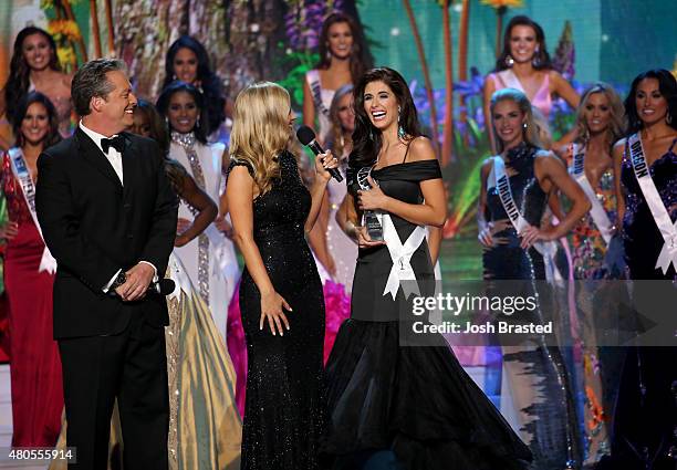 Hosts Todd Newton and Former Miss Wisconsin Alex Wehrley speak with Most Photogenic winner Miss Indiana Gretchen Reece onstage at the 2015 Miss USA...