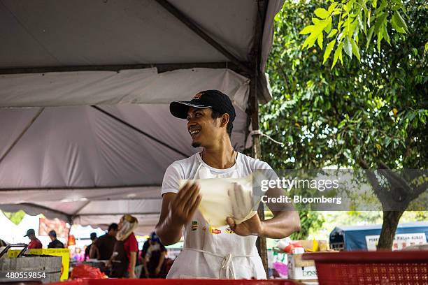 Chef prepares roti canai, a fried bread, at a food stall in a market in Johor Bahru, Johor, Malaysia on Friday, July 10, 2015. The ringgit has fallen...