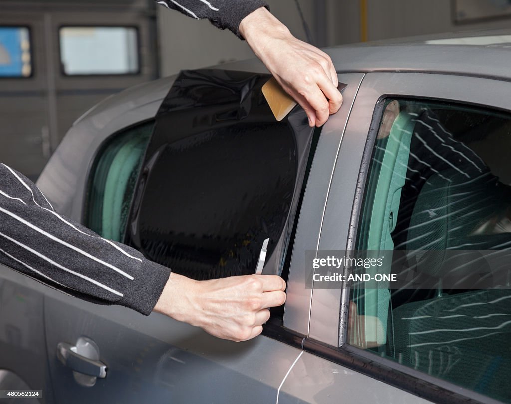 Applying tinting foil on a car window