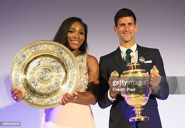 Serena Williams of the United States and Novak Djokovic of Serbia pose on stage at the Champions Dinner at the Guild Hall on day thirteen of the...