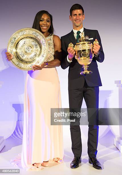Serena Williams of the United States and Novak Djokovic of Serbia pose on stage at the Champions Dinner at the Guild Hall on day thirteen of the...