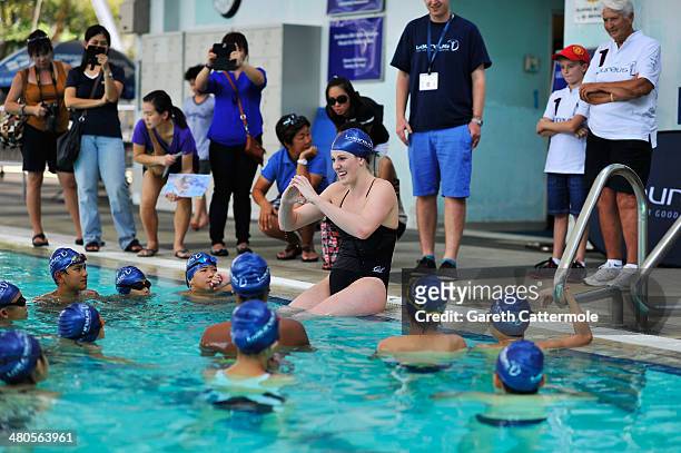 Swimmer Missy Franklin and Laureus World Sportswoman of the Year nominee gives a swimming lesson to local children during the Laureus Familiarization...