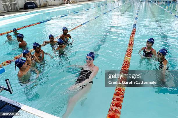 Swimmer Missy Franklin and Laureus World Sportswoman of the Year nominee gives a swimming lesson to local children during the Laureus Familiarization...