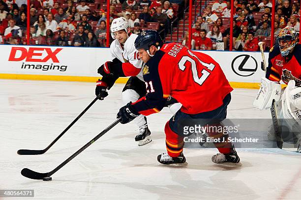 Krys Barch of the Florida Panthers skates with the puck against Clarke MacArthur of the Ottawa Senators at the BB&T Center on March 25, 2014 in...