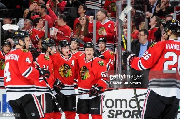 Duncan Keith of the Chicago Blackhawks celebrates with teammates Niklas Hjalmarsson, Patrick Sharp, Andrew Shaw and Michal Handzus after scoring...