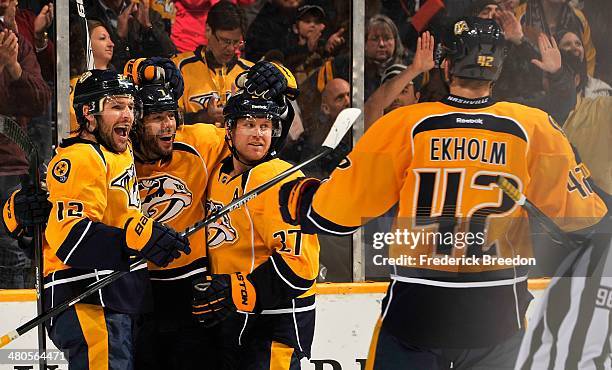 Matt Cullen of the Nashville Predators is congratulated by teammates Mike Fisher, Patric Hornqvist, and Mattias Ekholm on scoring a goal against the...