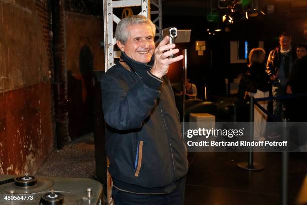 French director Claude Lelouch takes footage with his small video camera prior to the private screening of his latest feature film "Salaud, on...