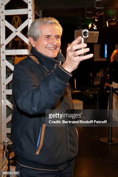 French director Claude Lelouch takes footage with his small video camera prior to the private screening of his latest feature film "Salaud, on...