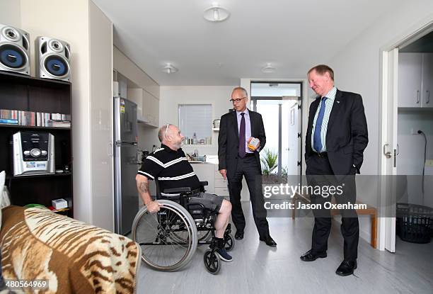 Dr Nick Smith Minister of Housing, and Glen Sowry, Housing New Zealand CEO, talk with resident Shane Kirkus in his home at the opening of Housing New...