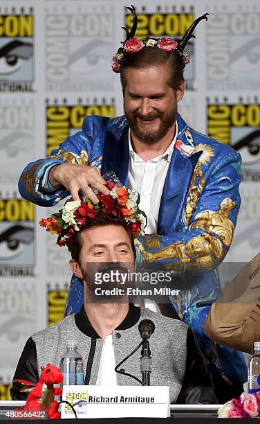 Executive producer/creator Bryan Fuller puts a flower crown on actor Richard Armitage at the "Hannibal" Savor the Hunt panel during Comic-Con...