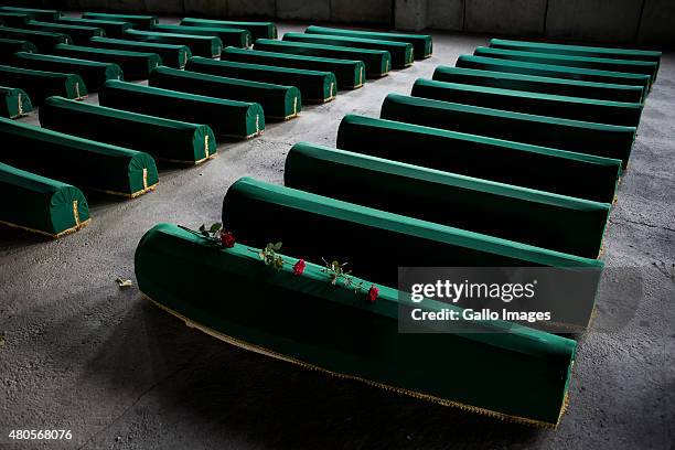 Roses lie on a coffin on July 9, 2015 at the Srebrenica- Potocari Memorial and Cemetery at Potocari, Bosnia. During the 1992-1995 Bosnian War, the...