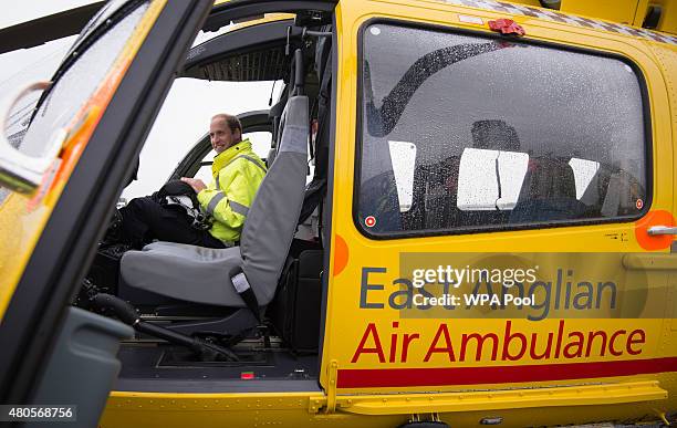 Prince William, The Duke of Cambridge sits in the cockpit of an helicopter as he begins his new job with the East Anglian Air Ambulance at Cambridge...