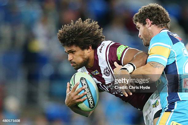Jayden Hodges of the Sea Eagles is tackled during the round 18 NRL match between the Gold Coast Titans and the Manly Sea Eagles at Cbus Super Stadium...